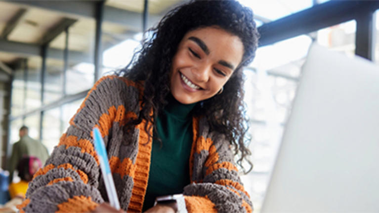 Smiling student working at a laptop