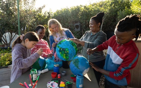 Teacher and students working together on project